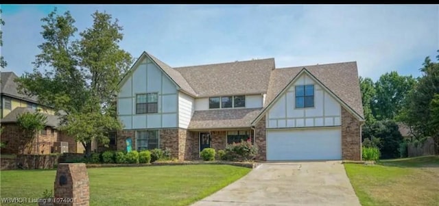 english style home featuring a front yard and a garage