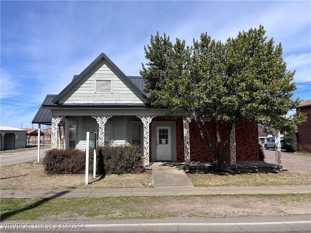 72 2nd St, Waldron, AR 72958 - view of front of home featuring a porch and metal roof