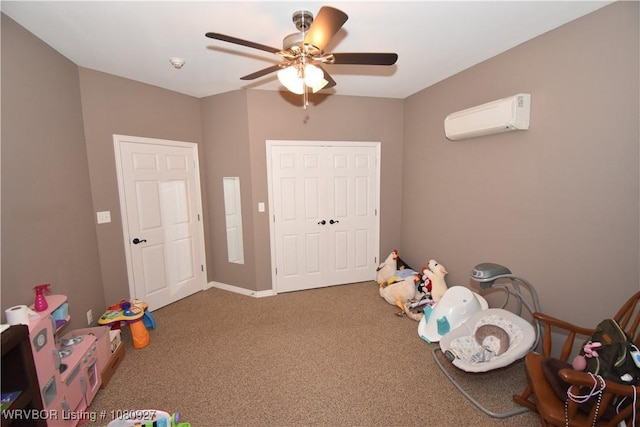 recreation room with a wall unit AC, a ceiling fan, and carpet