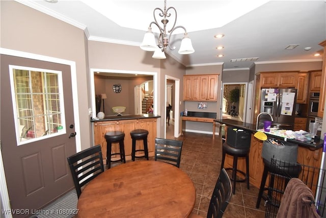 dining space with a chandelier, ornamental molding, dark tile patterned floors, and recessed lighting
