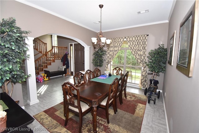 dining area featuring arched walkways, a chandelier, crown molding, stairway, and baseboards