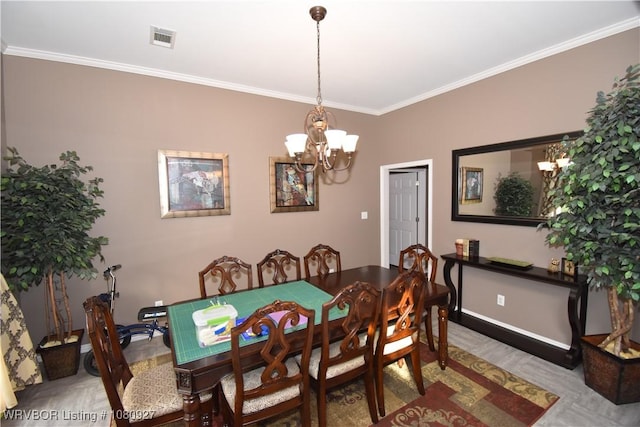 dining room with a chandelier, ornamental molding, and baseboards
