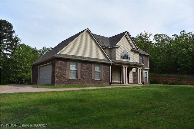 traditional-style house with brick siding, a front lawn, driveway, and a garage