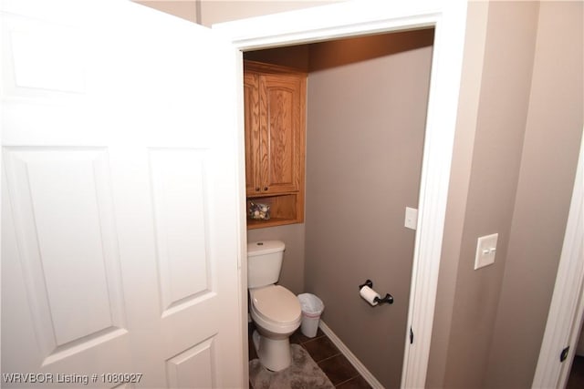bathroom with toilet and baseboards