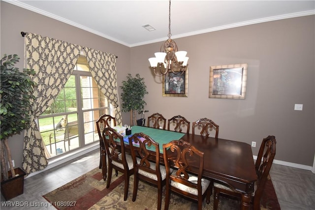 dining room with a chandelier, ornamental molding, and baseboards