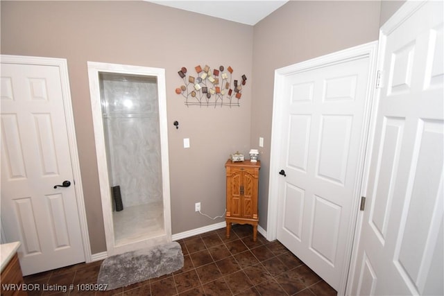 full bath with vanity, a shower, tile patterned floors, and baseboards