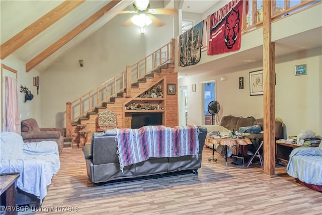 living room featuring beamed ceiling, hardwood / wood-style flooring, high vaulted ceiling, and ceiling fan