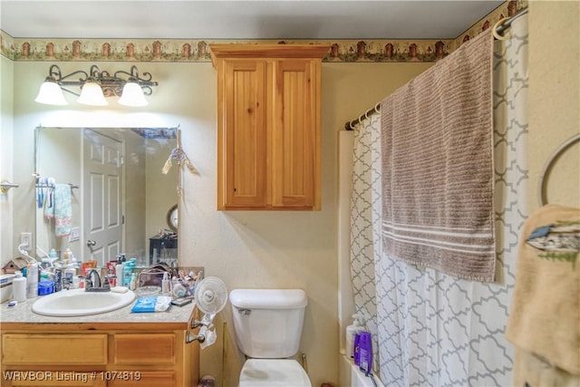 full bathroom featuring shower / bath combo, vanity, and toilet