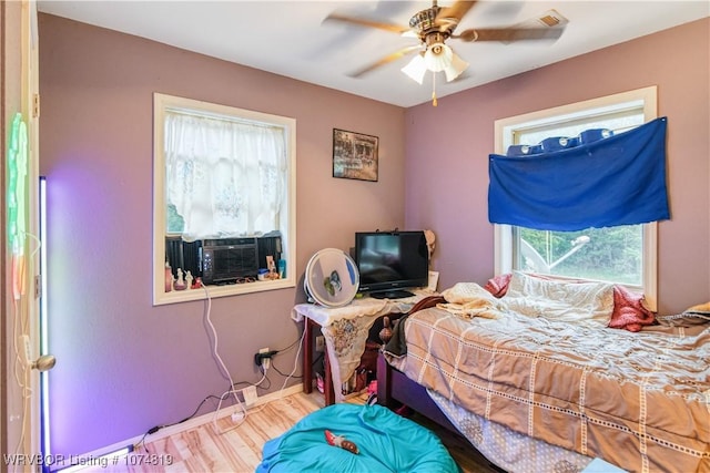 bedroom with ceiling fan and hardwood / wood-style flooring