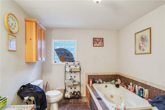 bathroom with tile patterned floors, tiled bath, and toilet