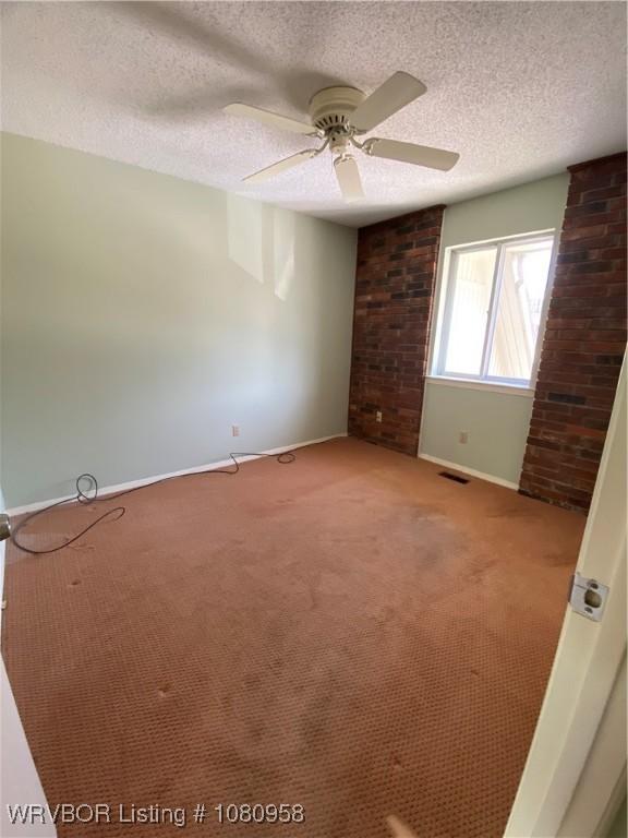 1500 S Albert Pike Ave Unit 40, Fort Smith, AR 72903 - spare room with light carpet, baseboards, a ceiling fan, and a textured ceiling