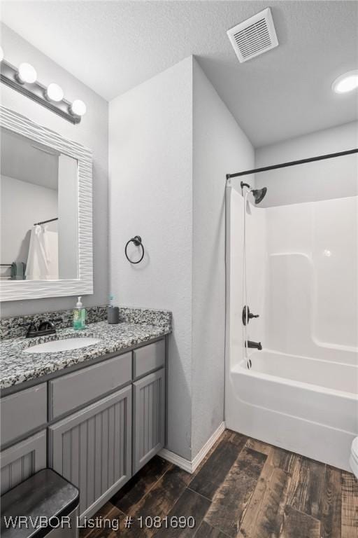 2207 Lisa Ln, Van Buren, AR 72956 - bathroom featuring wood finished floors, vanity, shower / bathtub combination with curtain, and a textured ceiling