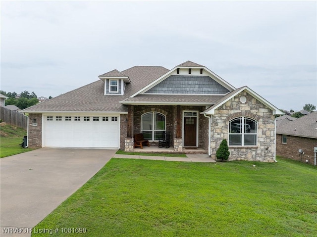 2207 Lisa Ln, Van Buren, AR 72956 - craftsman-style house featuring a garage, driveway, roof with shingles, a porch, and stone siding