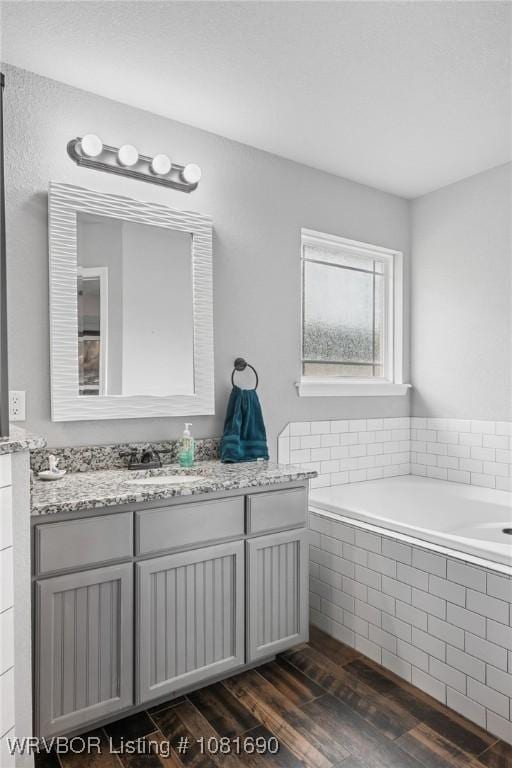 2207 Lisa Ln, Van Buren, AR 72956 - bathroom with a bath, vanity, and wood finished floors