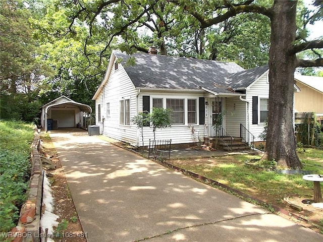 619 N 40th St, Fort Smith, AR 72903 - view of front of house with an outbuilding, a chimney, driveway, central AC, and roof with shingles