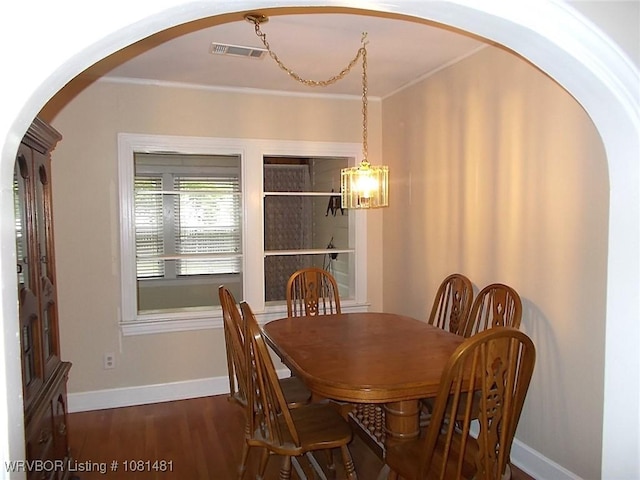 619 N 40th St, Fort Smith, AR 72903 - dining area featuring arched walkways, dark wood finished floors, a chandelier, baseboards, and crown molding