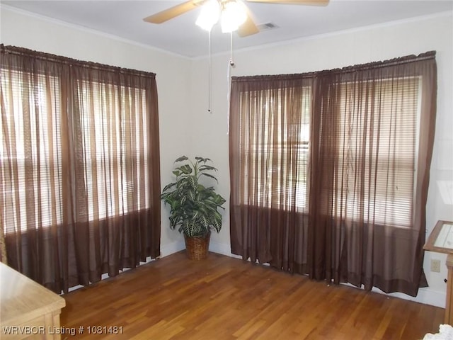 619 N 40th St, Fort Smith, AR 72903 - empty room featuring ceiling fan, wood finished floors, crown molding, and baseboards