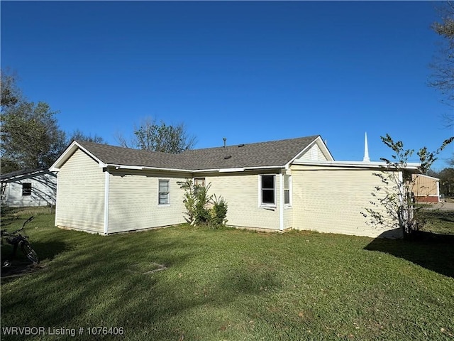 rear view of house with a lawn