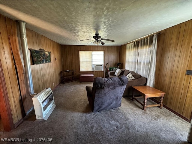 living room featuring dark colored carpet, ceiling fan, a textured ceiling, and heating unit