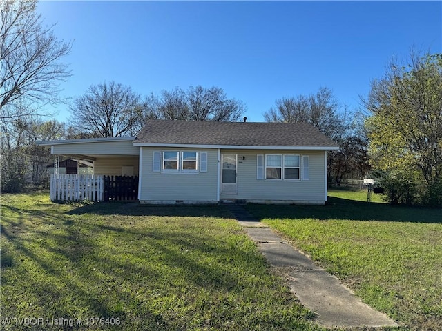 ranch-style home with a front yard and a carport