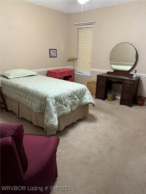 5108 S 94th St, Fort Smith, AR 72903 - carpeted bedroom featuring a textured ceiling