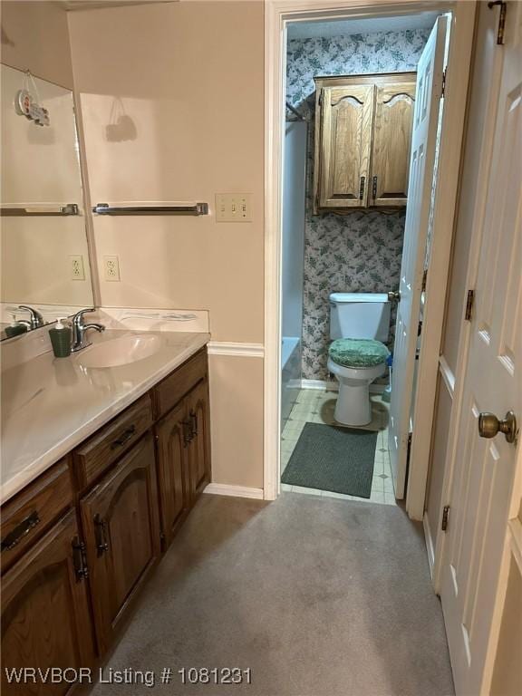 5108 S 94th St, Fort Smith, AR 72903 - bathroom with vanity, toilet, wallpapered walls, baseboards, and a tub