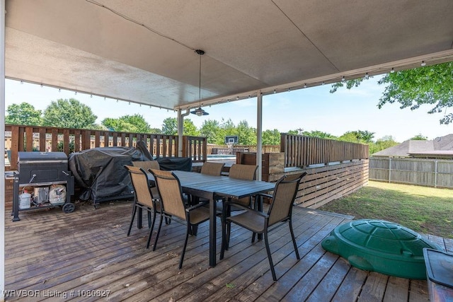 wooden deck featuring outdoor dining space and grilling area