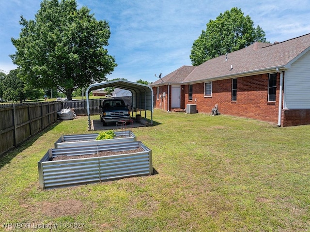 view of yard featuring cooling unit, a carport, and a garden