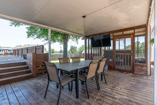 wooden deck featuring outdoor dining area and fence