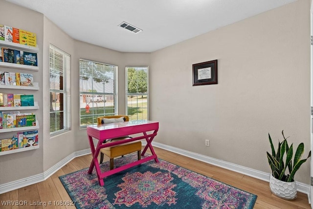 game room featuring wood-type flooring and baseboards