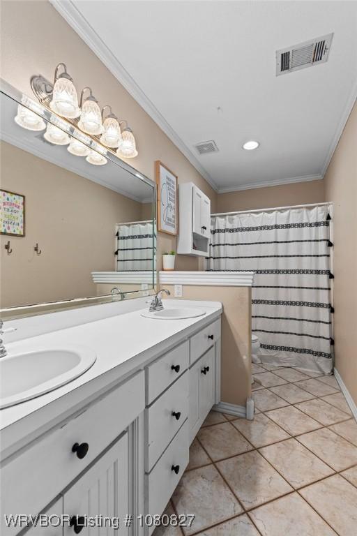 full bath with double vanity, ornamental molding, tile patterned floors, toilet, and curtained shower
