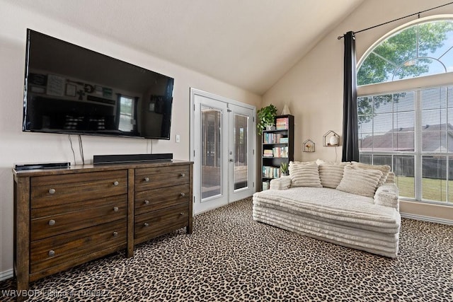 sitting room featuring french doors, lofted ceiling, and carpet flooring