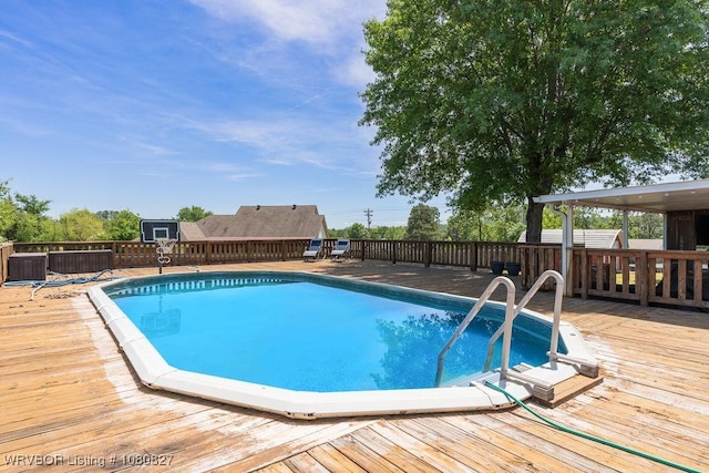 view of pool with a wooden deck
