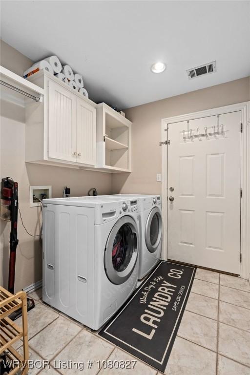 clothes washing area featuring washer and dryer, light tile patterned flooring, cabinet space, and recessed lighting