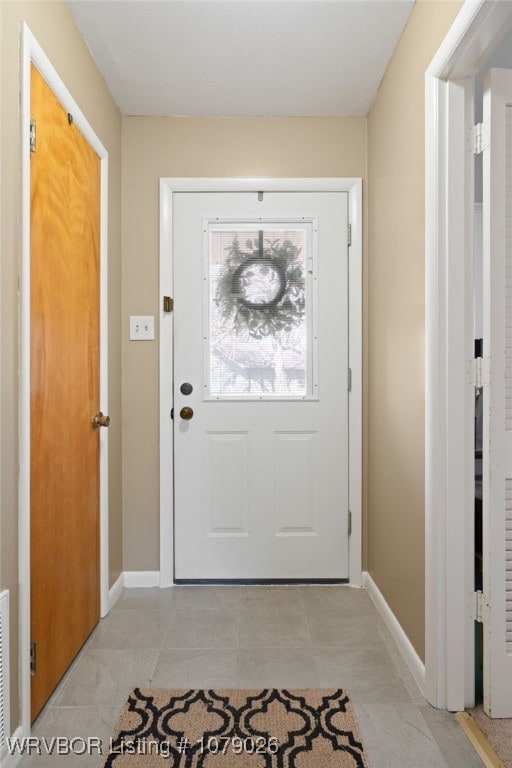 doorway featuring light tile patterned floors