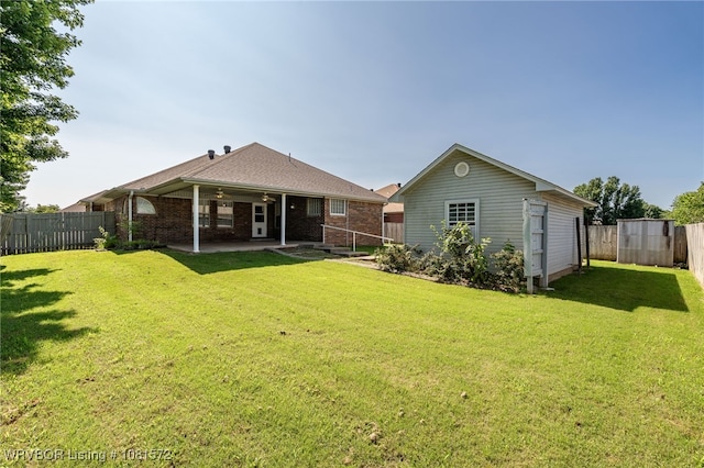 7004 Millennium Dr, Fort Smith, AR 72916 - rear view of property featuring a patio, a fenced backyard, a ceiling fan, brick siding, and an outdoor structure