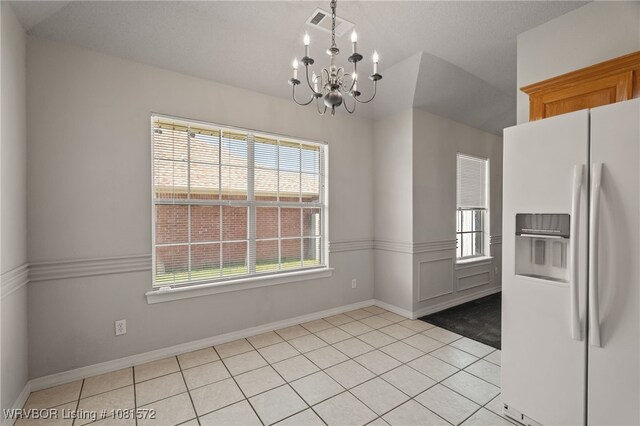 7004 Millennium Dr, Fort Smith, AR 72916 - unfurnished dining area featuring a chandelier, plenty of natural light, and light tile patterned floors