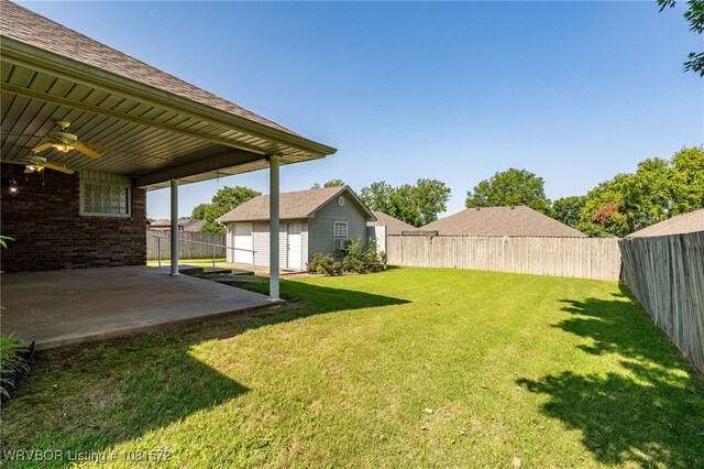 7004 Millennium Dr, Fort Smith, AR 72916 - fenced backyard with ceiling fan, a patio area, and an outdoor structure