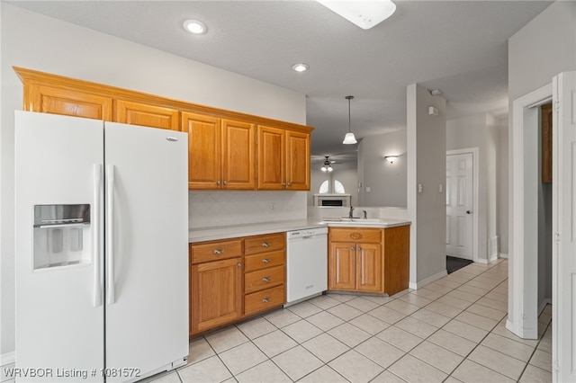 7004 Millennium Dr, Fort Smith, AR 72916 - kitchen with white appliances, light countertops, a ceiling fan, light tile patterned floors, and brown cabinetry