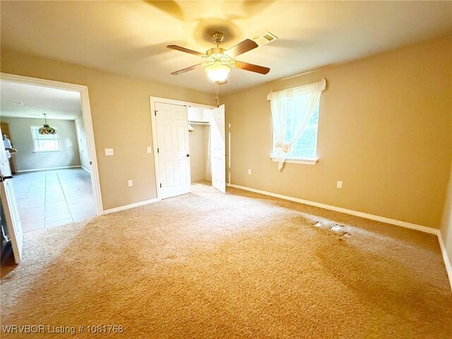 900 S Mattox Ln, Sallisaw, OK 74955 - unfurnished bedroom with carpet flooring, a ceiling fan, and a closet