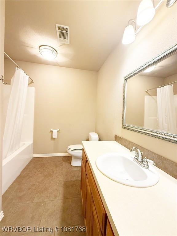 900 S Mattox Ln, Sallisaw, OK 74955 - bathroom featuring vanity, tile patterned flooring, and shower / bath combination with curtain