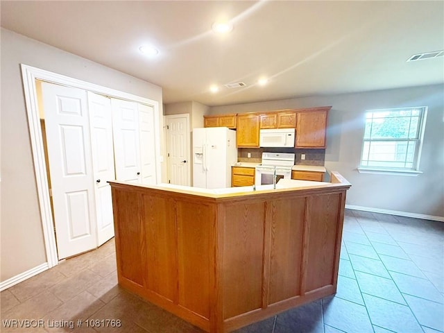 900 S Mattox Ln, Sallisaw, OK 74955 - kitchen with white appliances, light countertops, recessed lighting, and light tile patterned floors