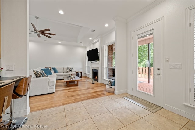 38 Jeffrey Way, Fort Smith, AR 72903 - living room featuring light tile patterned floors, recessed lighting, ornamental molding, a ceiling fan, and a warm lit fireplace