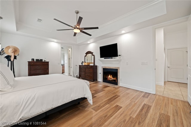38 Jeffrey Way, Fort Smith, AR 72903 - bedroom with a raised ceiling, light wood-type flooring, a tile fireplace, ornamental molding, and recessed lighting