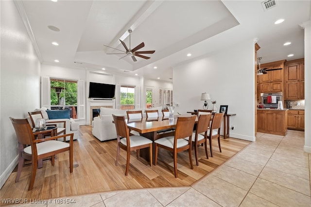 38 Jeffrey Way, Fort Smith, AR 72903 - dining room featuring a ceiling fan, light tile patterned flooring, a tray ceiling, recessed lighting, and a warm lit fireplace
