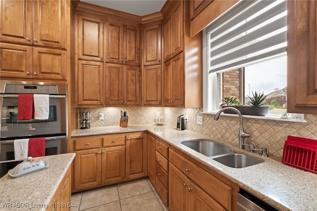 38 Jeffrey Way, Fort Smith, AR 72903 - kitchen with a sink, appliances with stainless steel finishes, brown cabinets, and tasteful backsplash