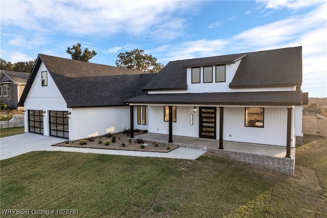 view of front of house with a front lawn, a porch, and a garage