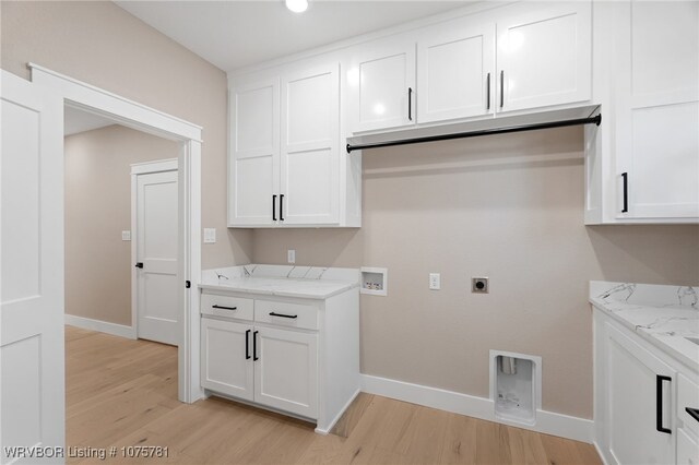 laundry area featuring cabinets, washer hookup, light hardwood / wood-style flooring, and hookup for an electric dryer