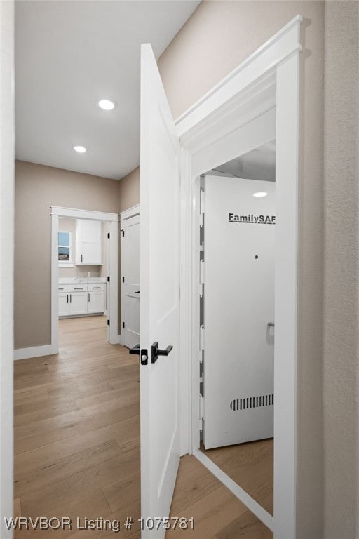 corridor with light hardwood / wood-style flooring