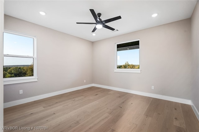 spare room with ceiling fan and light hardwood / wood-style floors